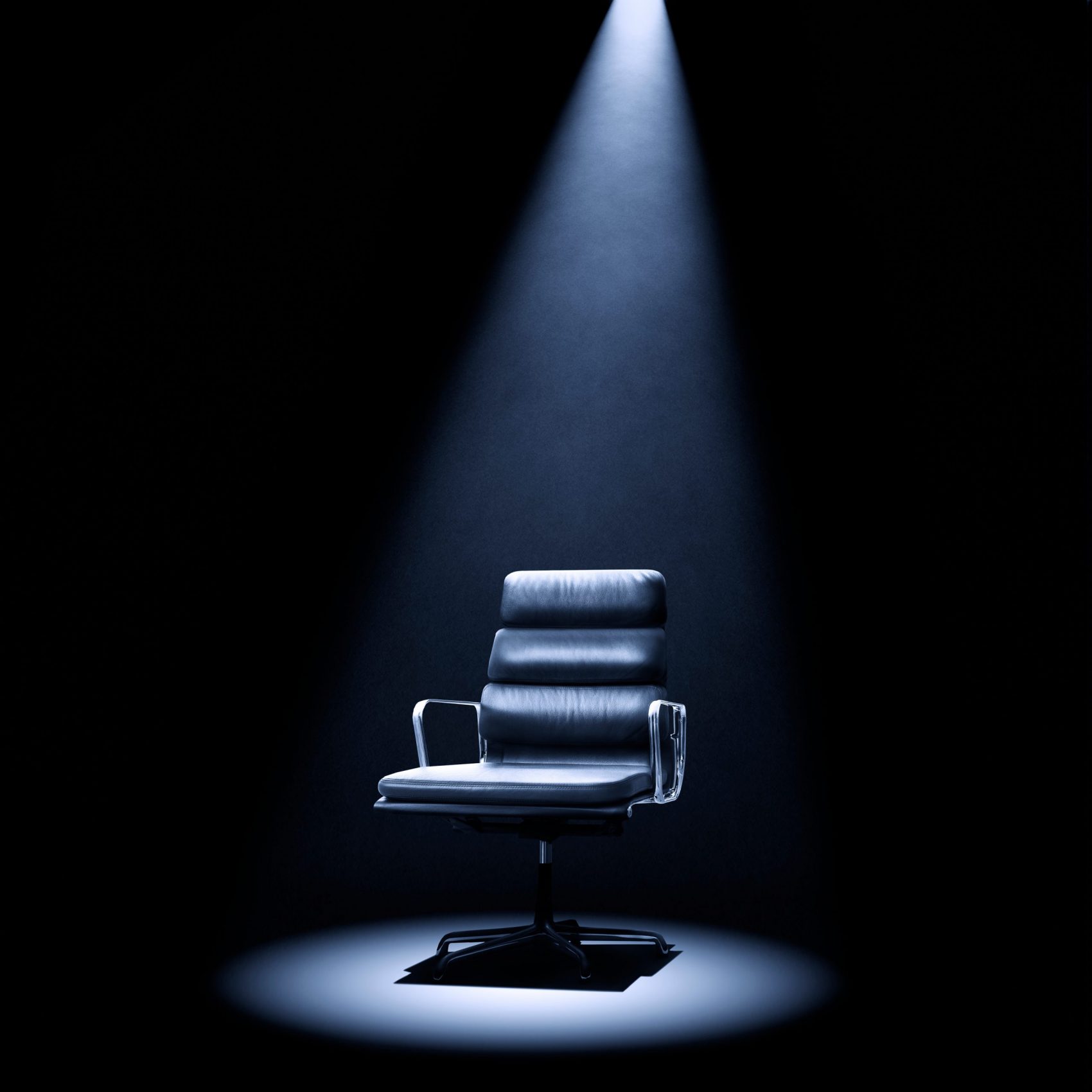 Mastermind-style Eames 219 chair under spotlight.